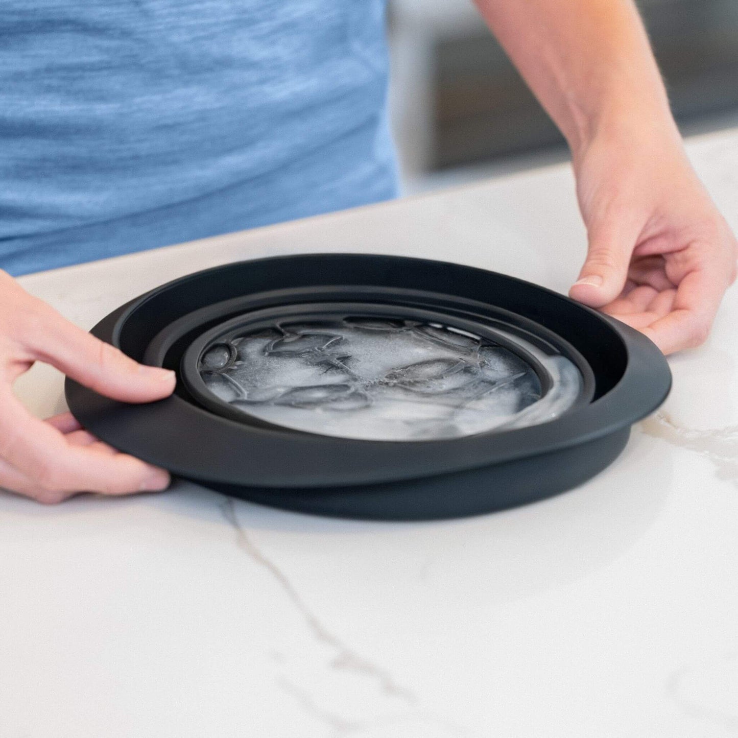 Frozen facial icer bowl with built-in tray ready for popping the ice before face plunge.
