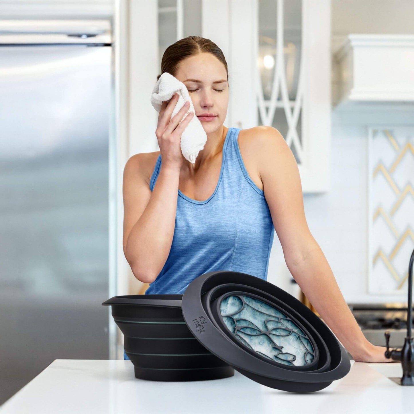 Woman refreshing her face after ice facial plunge using a cold water face bowl.