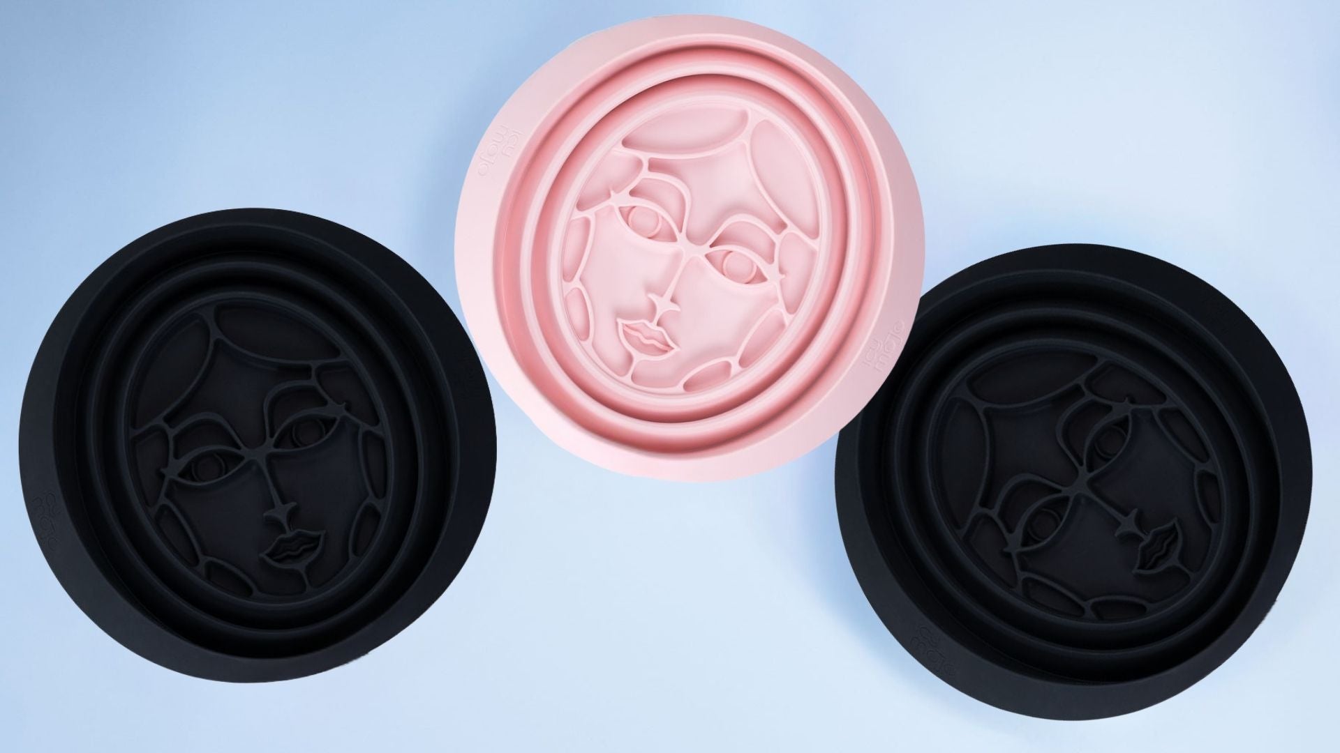 Three collapsible silicone bowls with built-in icytray in midnight blue and soft pink on a light blue background.